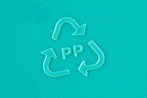 Closeup of PP with a chasing arrows recycling symbol.