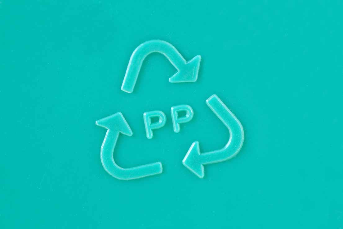 Closeup of PP with a chasing arrows recycling symbol.