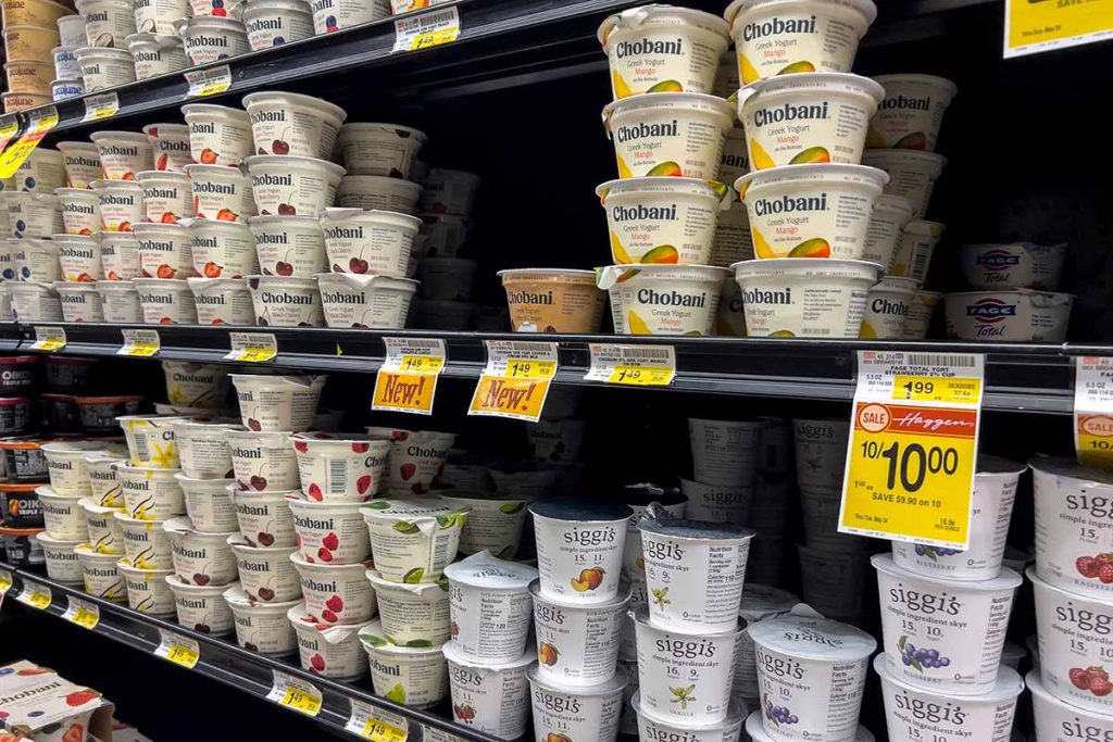 Grocery store shelf showing polypropylene yogurt tubs.
