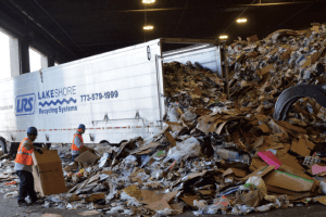 Workers with recycling materials at a MRF.