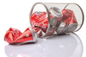 Coca Cola cans in a bin for recycling.