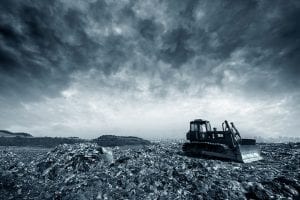 Heavy machine at a landfill site.