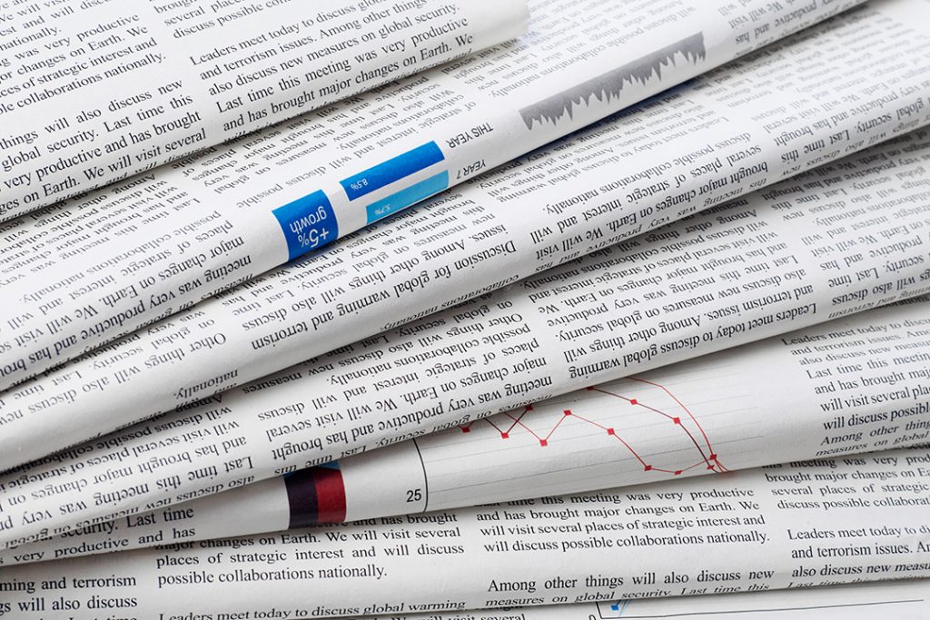 Close up of stacked newspapers.