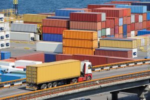 Cargo containers stacked at a logistics hub.