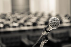 Microphone on stage in front of meeting room.