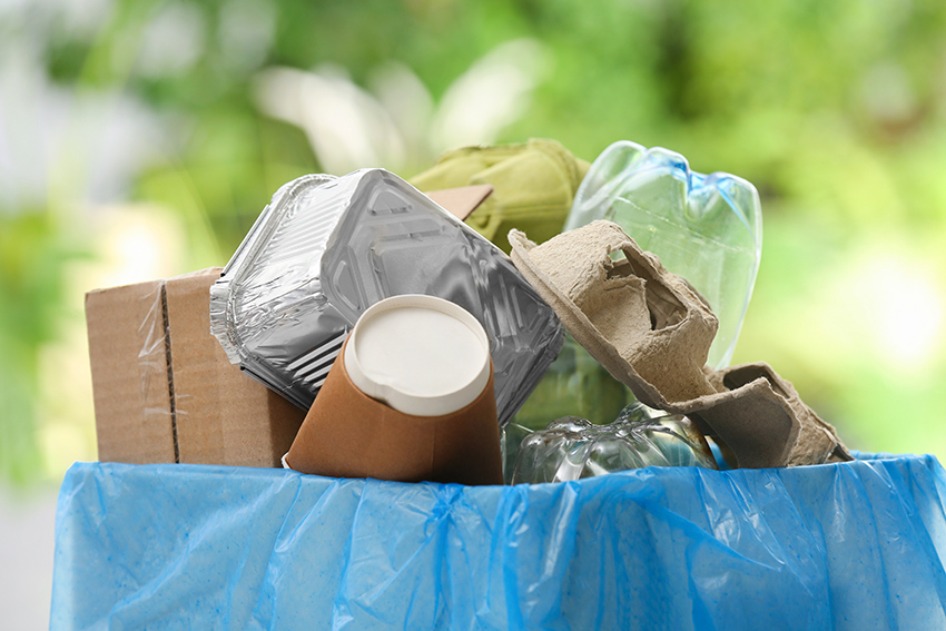 A bag of mixed household recycling including contamination.