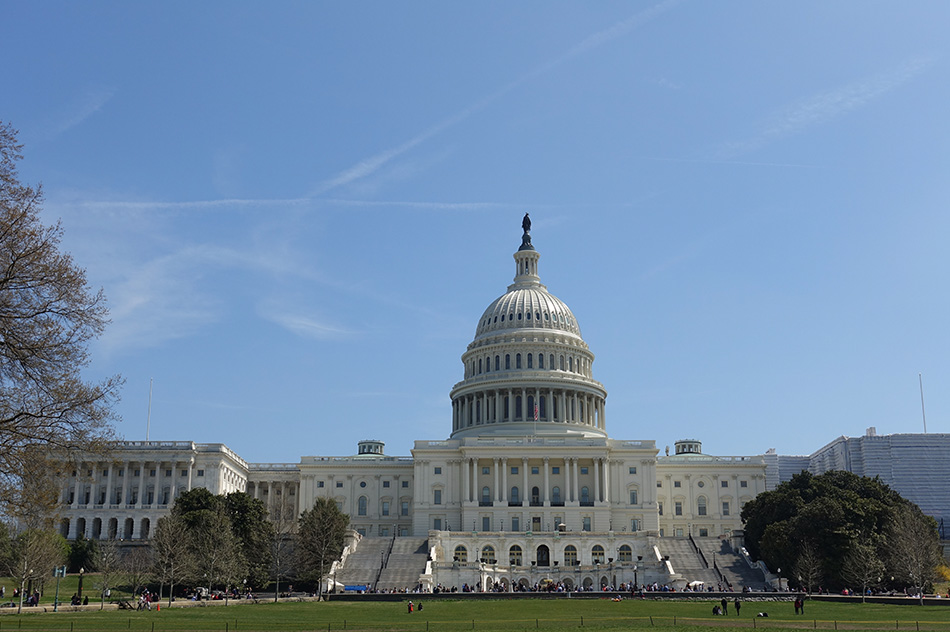 U.S. Capitol building in Washington, D.C. with blue sky above.