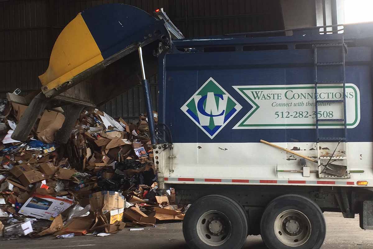 Waste Connections recycling collection truck unloads material at the Balcones MRF in Austin, Texas.