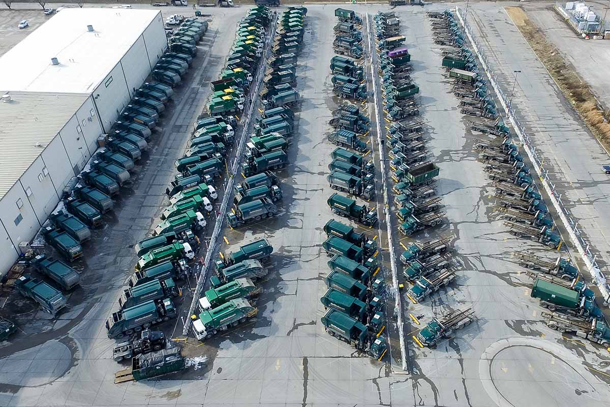 Waste Management fleet of trucks from above.