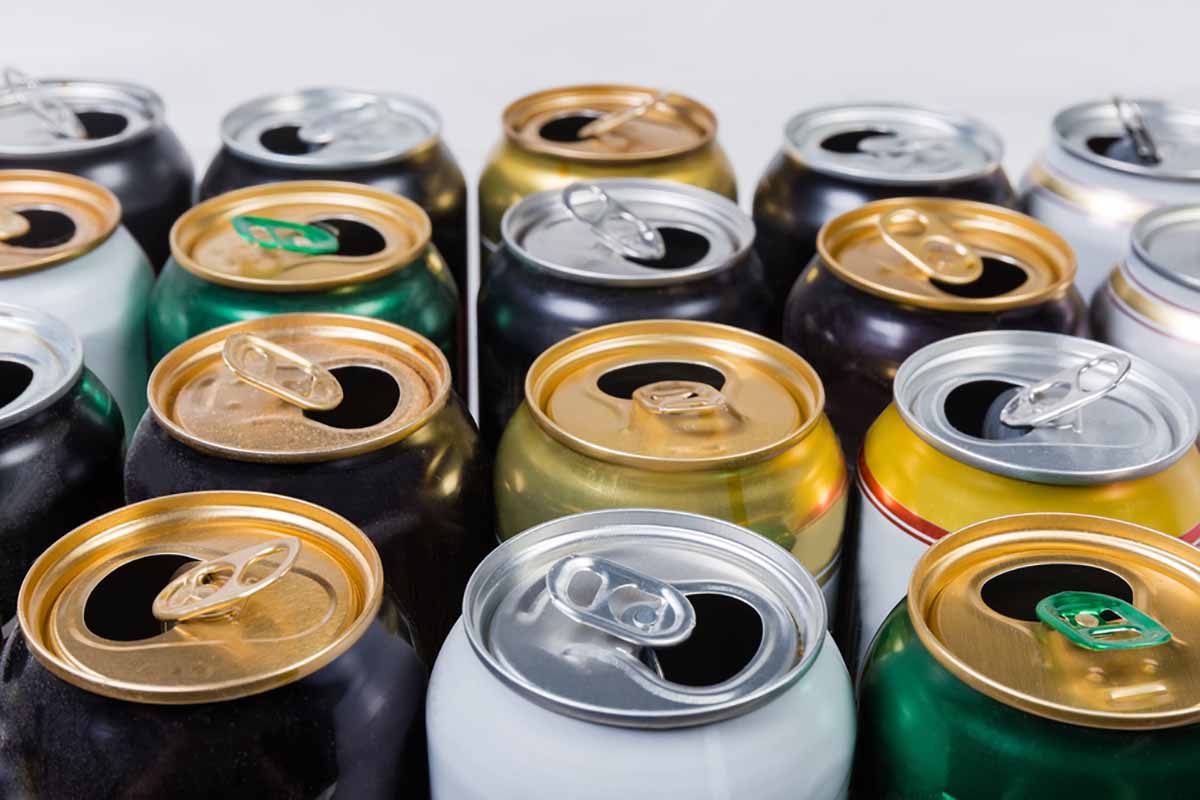 Empty aluminum beverage cans arranged in rows.