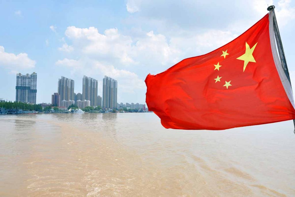 Chinese flag with the Yangtze River in background.