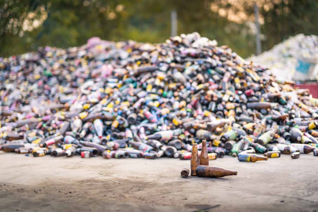 Glass bottles piled for recycling.