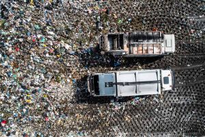 Trucks at a landfill site from above.