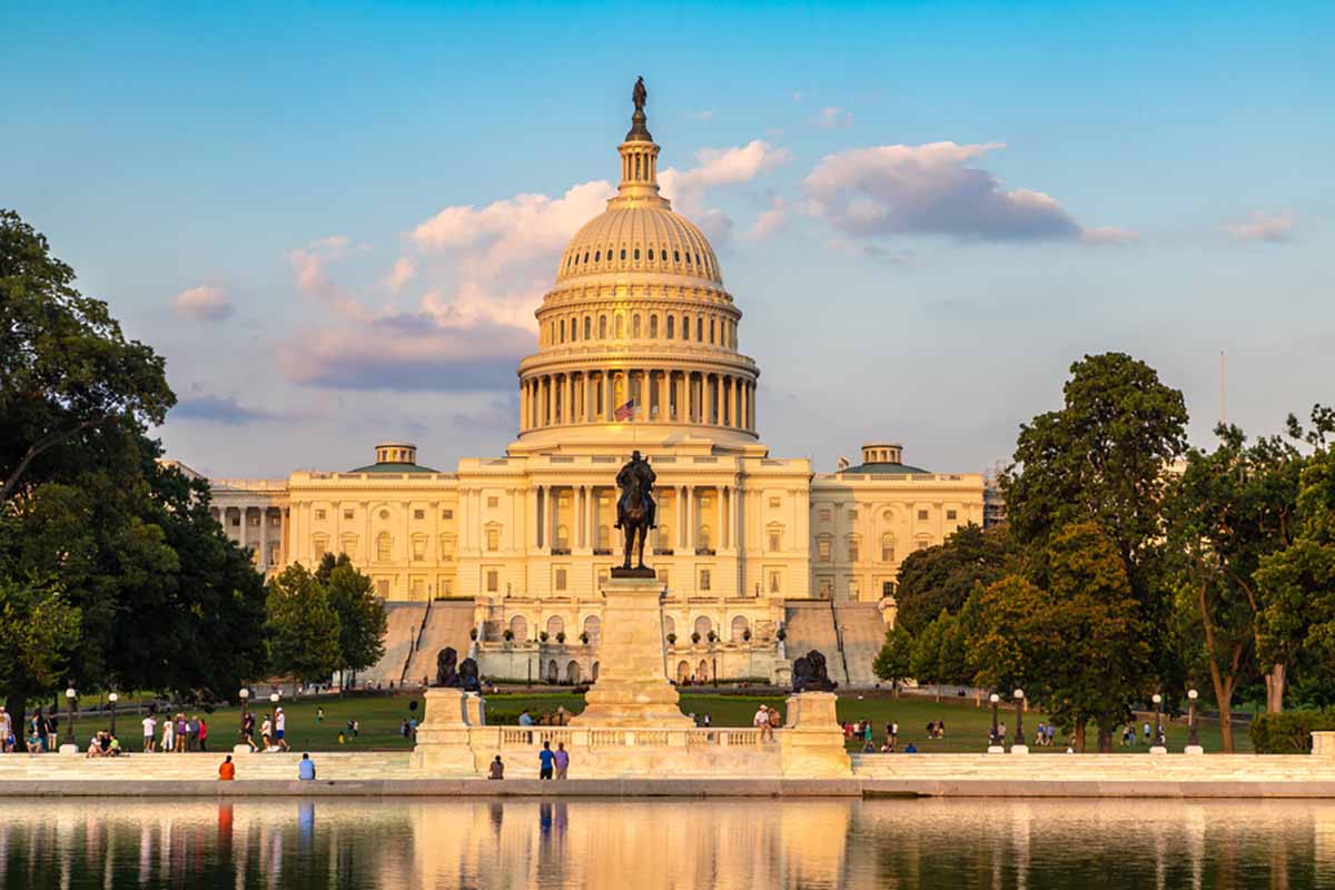 U.S. Capitol with reflecting pond in foreground.