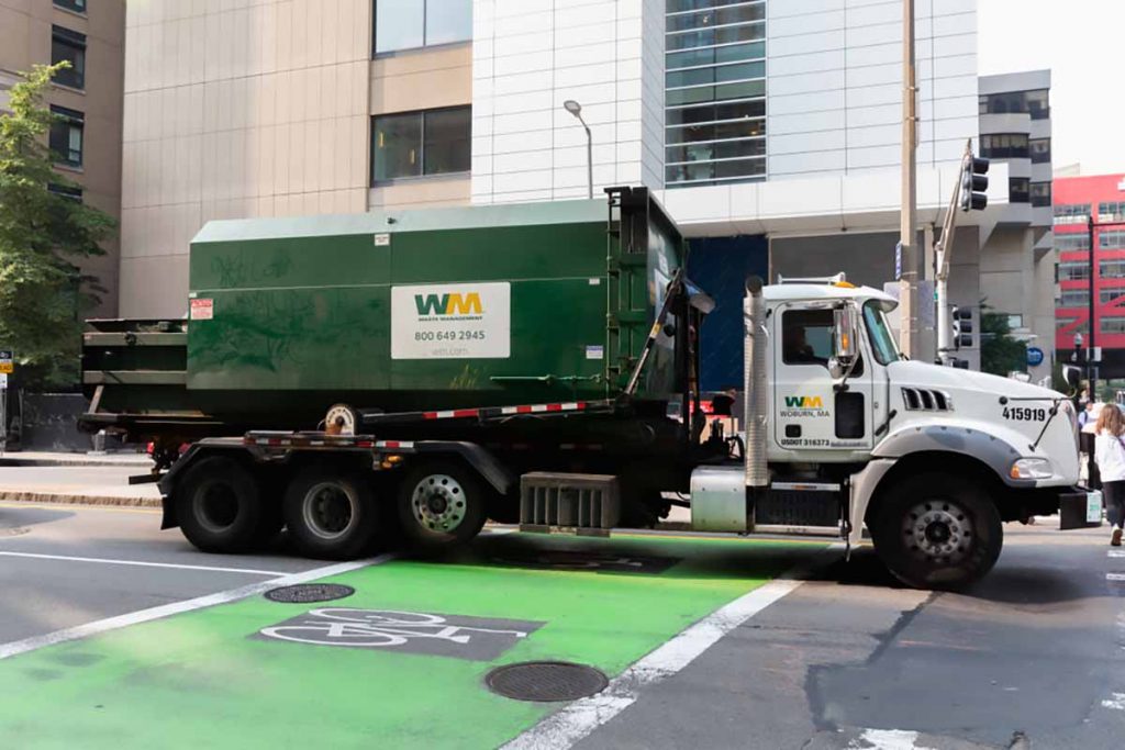 WM truck on a city street. 