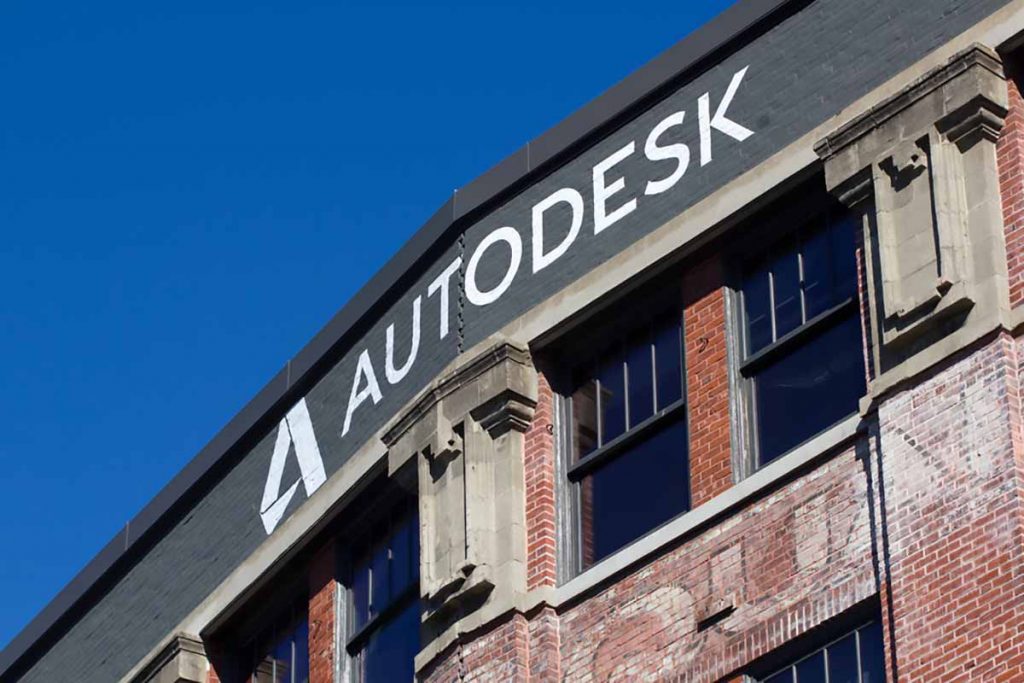 Autodesk sign on building with blue sky above.