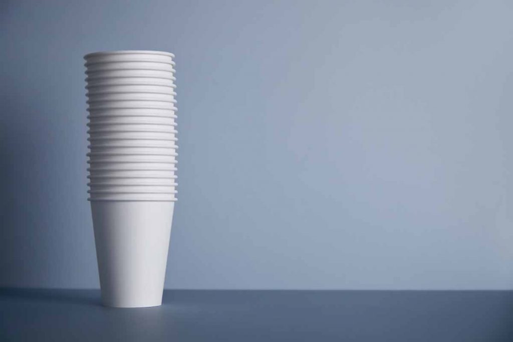 Paper coffee cups stacked for recycling.