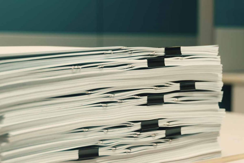 Documents stacked in an office.