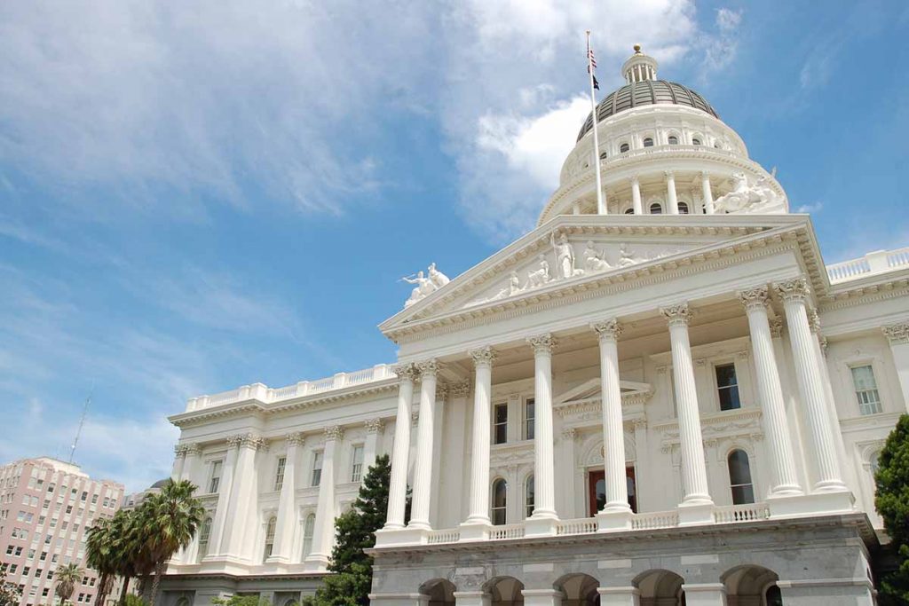California's state capitol building seen with blue sky above.
