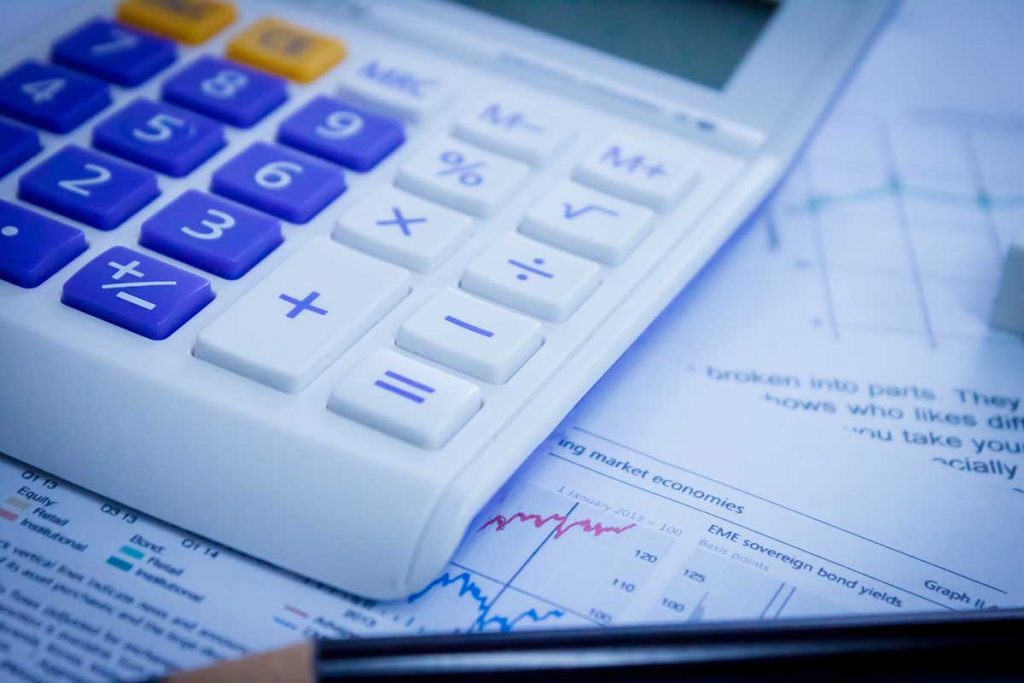 Accounting scene with calculator, pencil and documents.