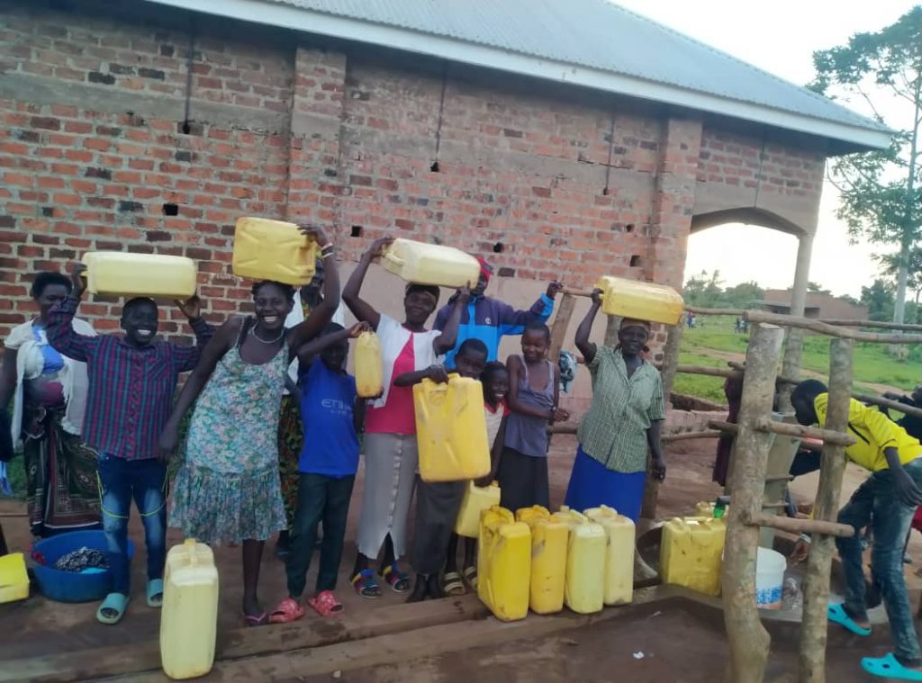 People in South Sudan (or maybe Uganda?) receive clean water from Kubi for Hope, Denis Kweri