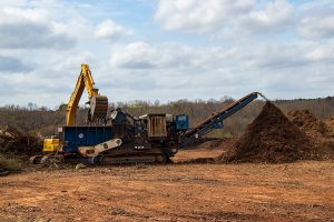 Athens, Georgia – March 14, 2019: Leaf and limb debris is loaded into a shredder, the first step in commercial compost production at the Athens-Clarke County landfill.