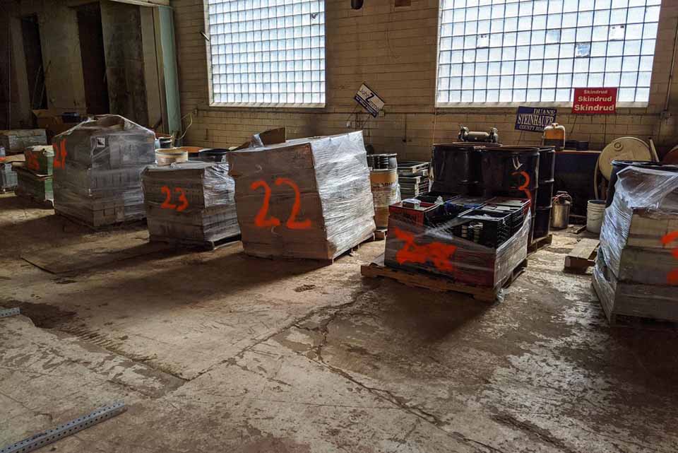 Batteries stacked for cleanup in a facility.