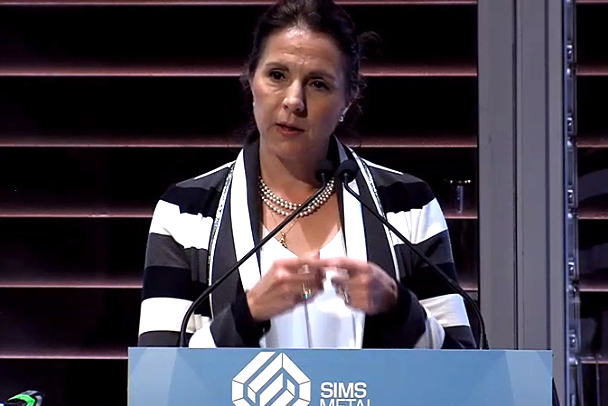 Ingrid Sinclair presenting on stage.