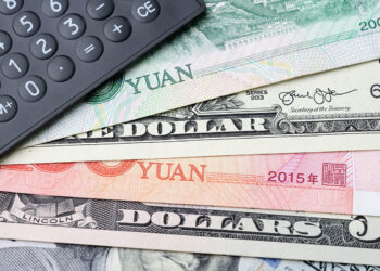 U.S. and Chinese currency with a calculator.