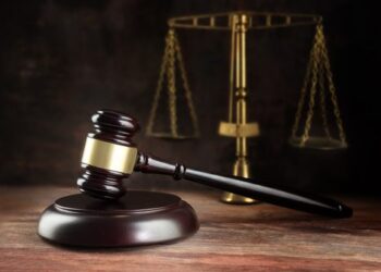 Court gavel and scales on table.