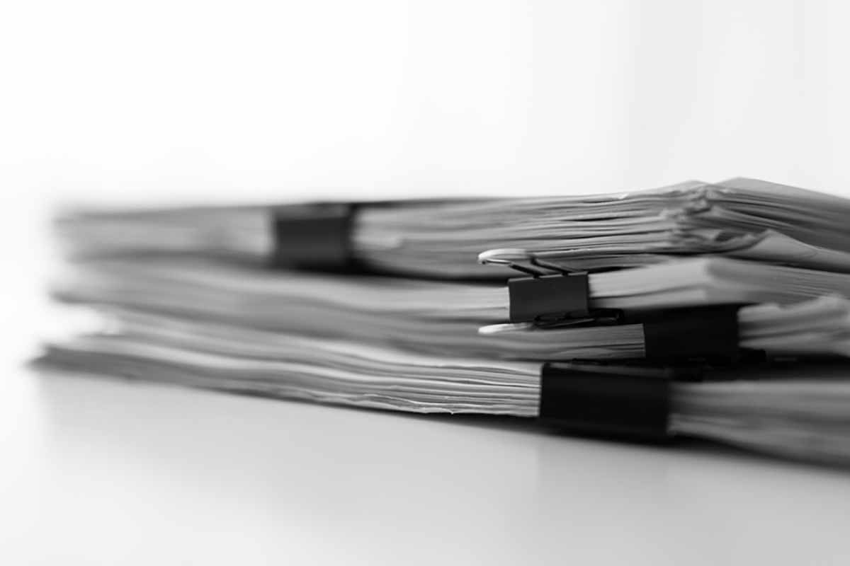 Documents clipped together in black and white.