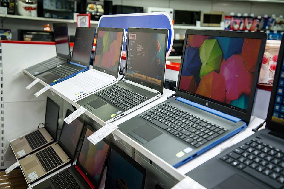 Laptops displayed at an electronics store.