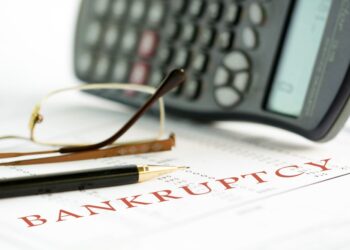 Bankruptcy paperwork with calculator.