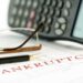 Bankruptcy paperwork with calculator.
