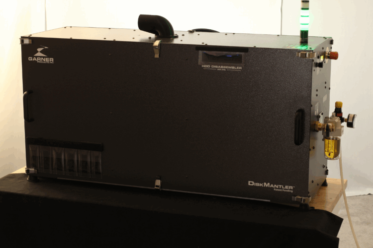 Device jostles hard drives apart for component recovery