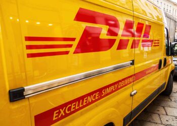 DHL truck parked on a city street.