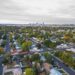 Aerial view of a Denver neighborhood with city skyline in background.