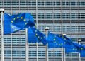 EU flags in front of the European Commission's building.