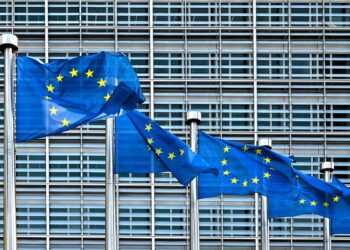 EU flags in front of the European Commission's building.