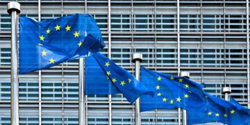 EU flags in front of the European Commission's building.
