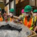 Employees of KC Recycling handle PP pellets the company has processed.