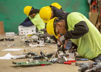 Employees at the RecycleForce facility dismantle electronics.
