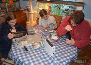 Family repairing devices before donating.Samsung