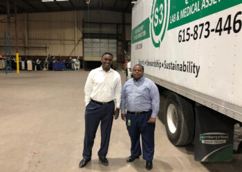S3 company CEO and Chairman stand by a company truck.
