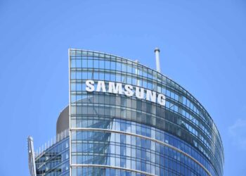 Samsung company sign on building with blue sky background.