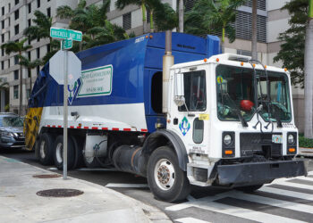Waste Connections company truck on an urban street.