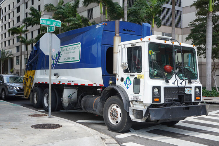 Waste Connections company truck on an urban street.