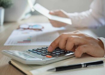 Calcuating at a desk.