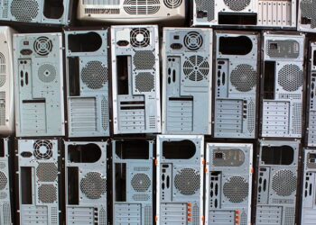 Rows of desktop computer cases for recycling.