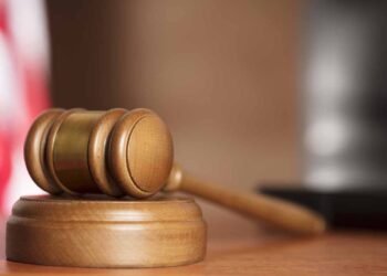 Court gavel resting on desk.